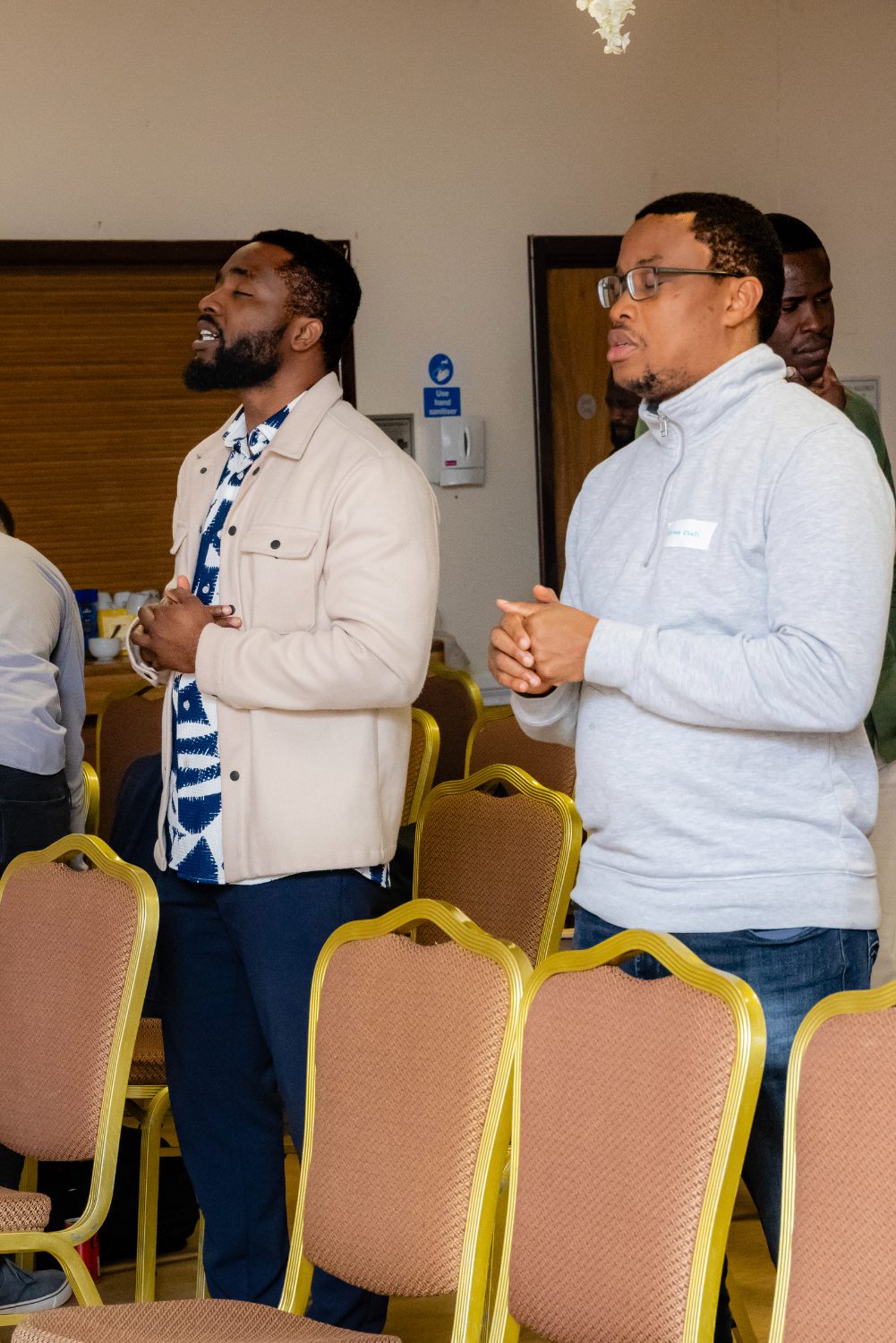 Men standing together in prayer